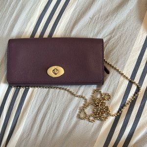 Purple Coach wallet with attachable chain.